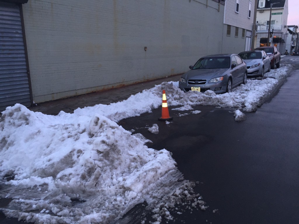A traffic cone saves a parking space on K Street on Monday, Jan. 25, 2016.