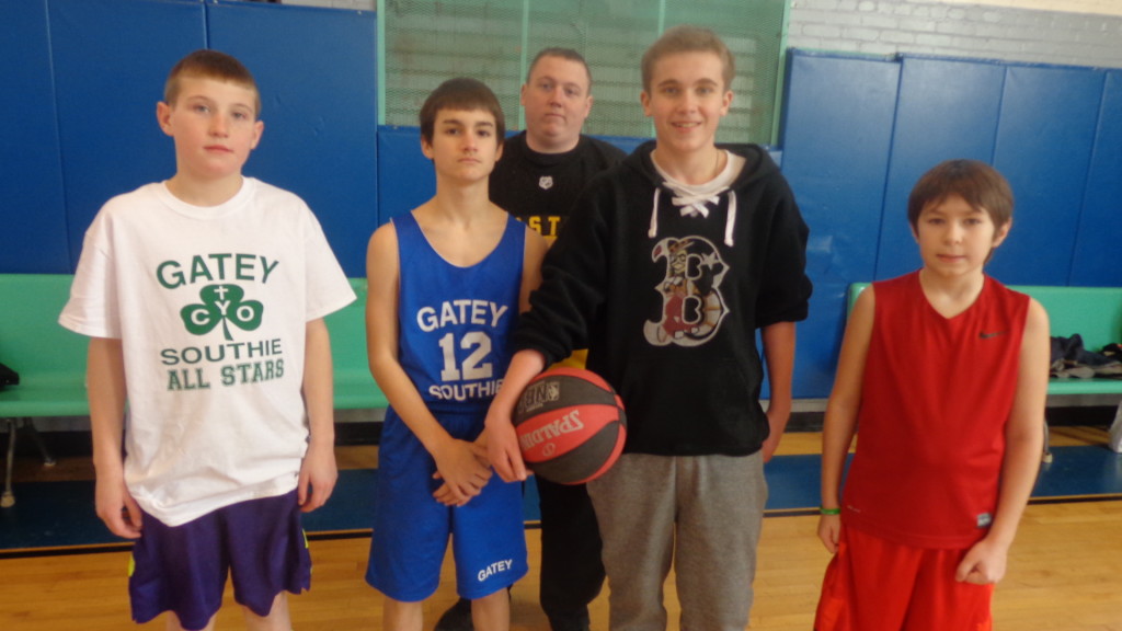 Pictured (from left) are free throw participants Colmn Gilroy, Dan Mahoney, Tommy White and Chris Hosea. In back is Knights of Columbus volunteer, young Steve Greig. 