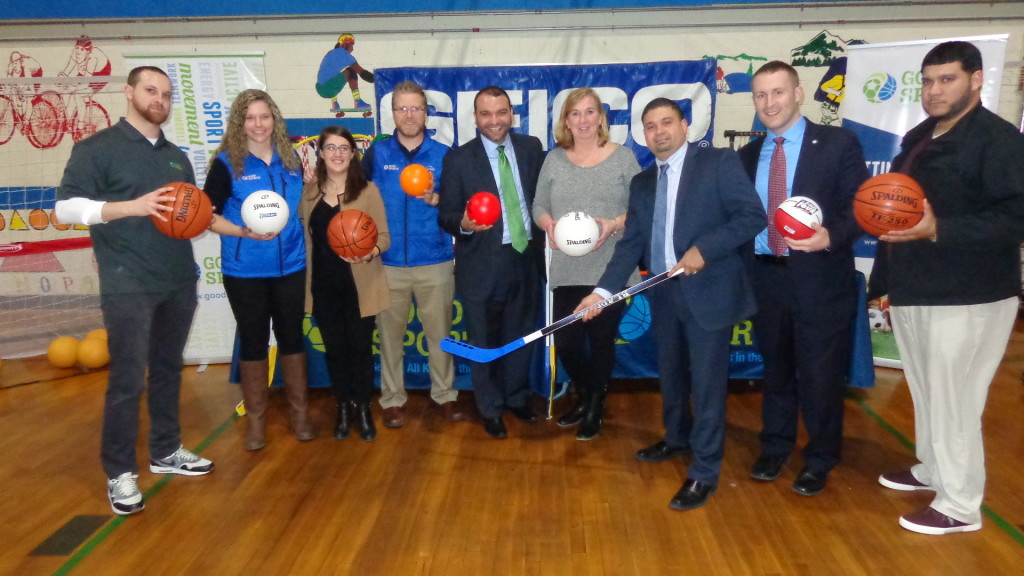 Pictured (from left) at the Tynan Community Center gym are: Good Sports Operations Director Vaughn Pfeffer, Good Sports Partnerships Assistant Kayley Gallagher, GEICO representative Samantha Freedman, Good Sports Community Partnerships Manager Michael Wright, City of Boston Commissioner of Health and Human Services Felix Arroyo, Tynan CC Program Supervisor Kathy Davis, BCYF Commissioner Will Morales, BCYF Deputy Commissioner Mike Sulprizio, and BCYF Director of Operations Hector Alvarez. 