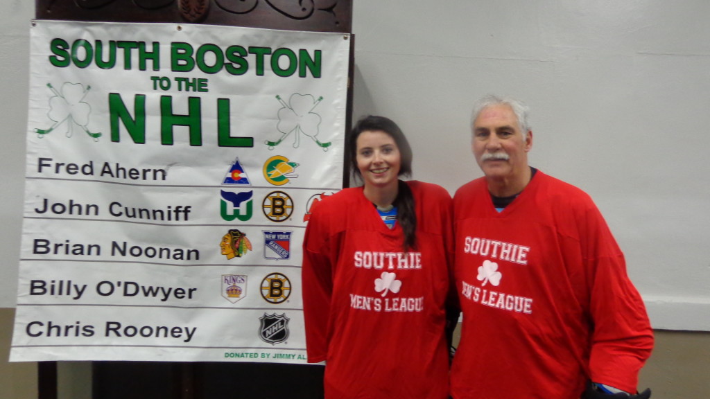 Kelly Foley poses with Fred Ahern, the youngest and oldest participants, respectively, in the South Boston Youth Hockey League alumni game.