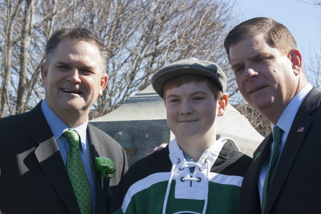 South Boston Citizens' Association President Tom McGrath (left) and Boston Mayor Martin J. Walsh (right) pose with Sean Loftus on Thursday, March 17, 2016. Sean, a student at Boston Latin Academy, is one of the essay contest winners and was recognized during the Evacuation Day memorial and historic exercises at Dorchester Heights. (Photo by Susan Doucet)