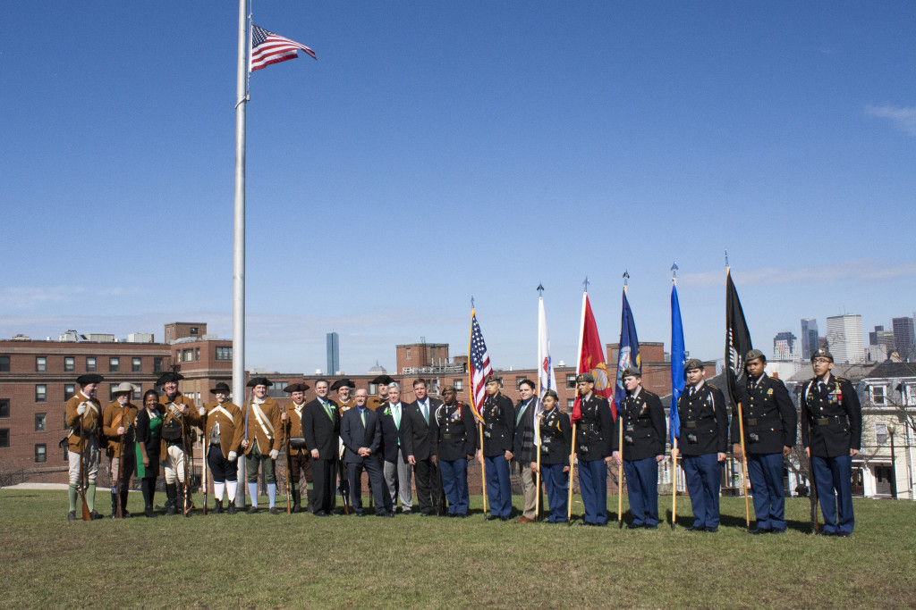 Participants in the Evacuation Day memorial and historic exercises gathered for a photo at the end of the ceremony at Dorchester Heights on Thursday, March 17, 2016. (Photo by Susan Doucet)