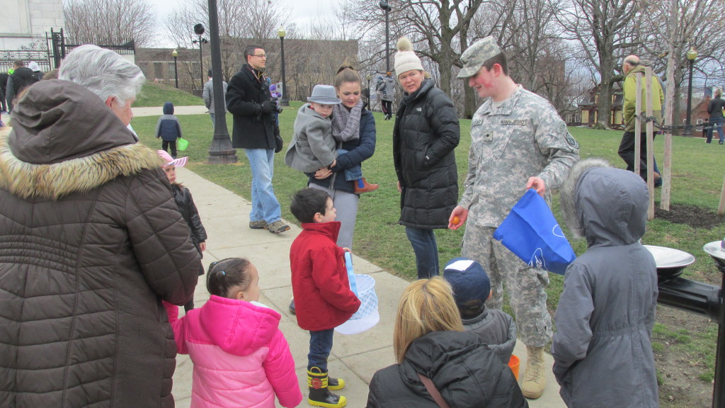 A JROTC Cadet from the high school passes out Easter egg hunt clues.