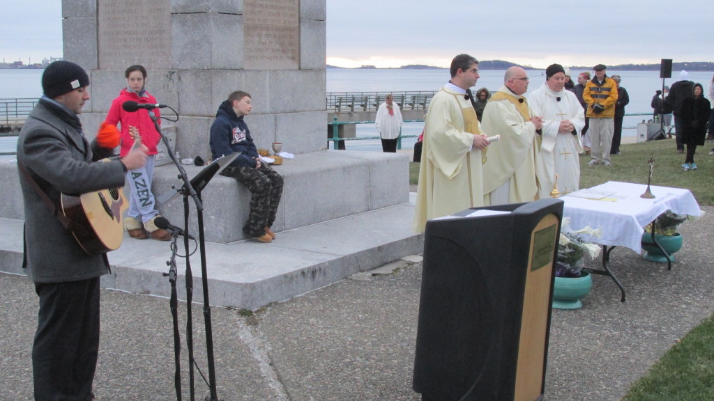 Fr. Robert Casey, paster at St. Brigid Parish, (center at the altar) begins the Easter Mass at sunrise.