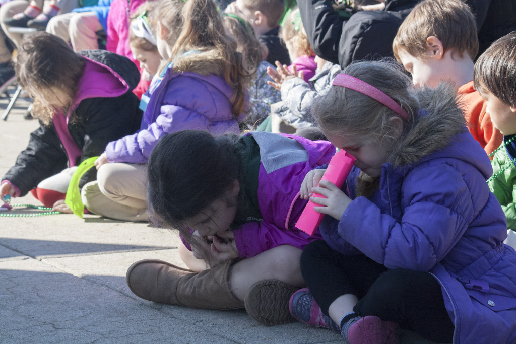 Students entertain themselves during the Evacuation Day memorial and historical exercises at Dorchester Heights on Thursday, March 17, 2016. (Photo by Susan Doucet)