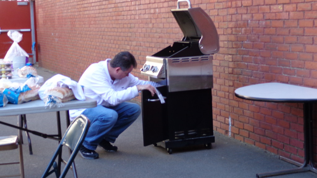 Tynan Administrative Coordinator John Lydon gets the grill started. 