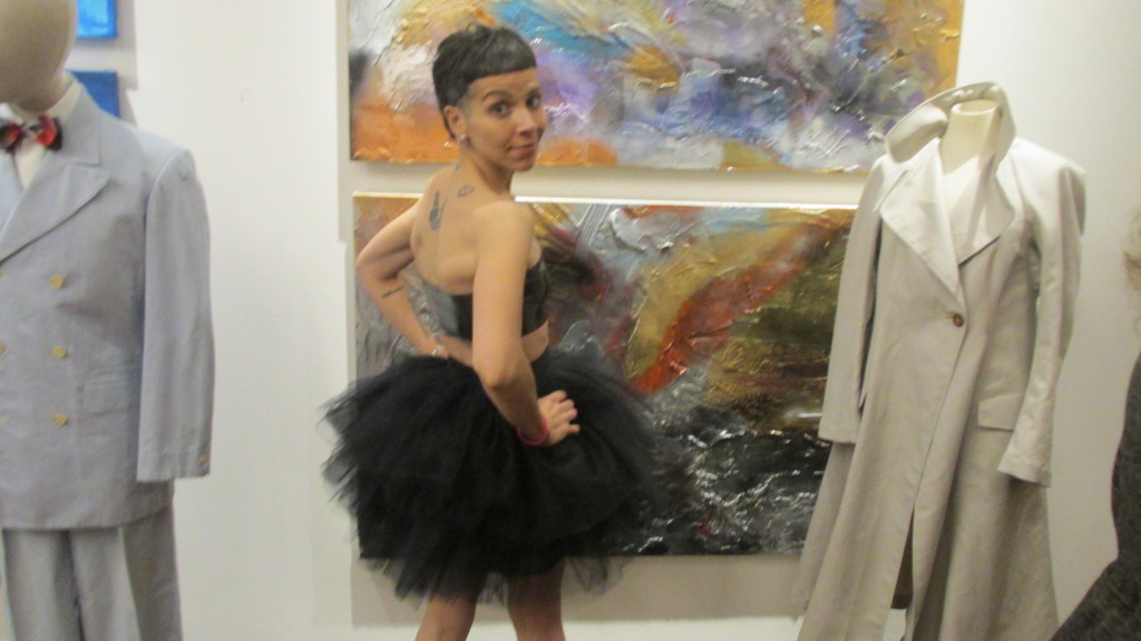 A tutu and tattoos are modeled at Midway Studio’s exhibition.