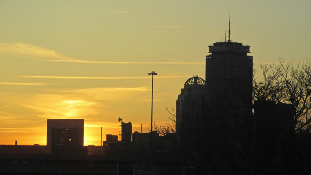 The mid-spring sun hides its sunset bedtime behind Boston’s building skyline. (Photo by Rick Winterson)