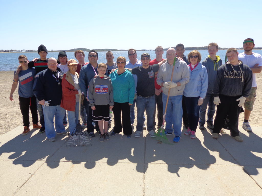 Rep. Nick Collins and John McGahan, the president and CEO of the Gavin Foundation, are pictured with Boston Shines volunteers at the South Boston Lagoon. (Photo by Kevin Devlin)