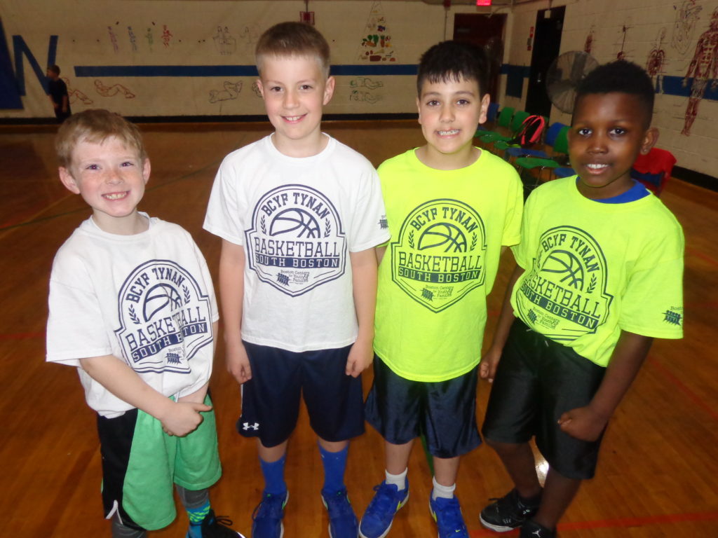 At the Tynan Community Center gym, young kids are learning the fundamentals of hoop, as they play in the under 11 co-ed basketball league, sponsored by the South Boston Community Foundation. Pictured (from left) are Braeden, Mike, Keith and Mark. (Photo by Kevin Devlin)