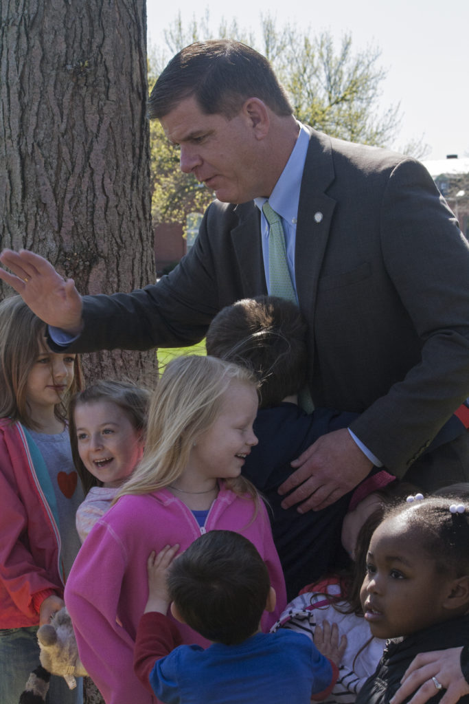 Liam Nagle, 5, hugs Mayor Martin J. Walsh as Walsh high-fives another child from Julie's Family Learning Program after posing for a photo with the group. The children were at Medal of Honor Park for the neighborhood coffee hour with Walsh on Tuesday, May 10, 2016. (Photo by Susan Doucet)