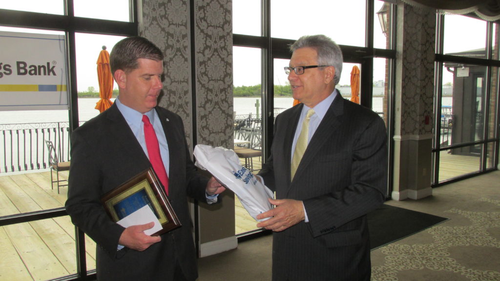 At the close of the East Boston Savings Bank Business Breakfast, Mayor Marty Walsh receives a gift and an award from bank CEO Dick Gavegnano.