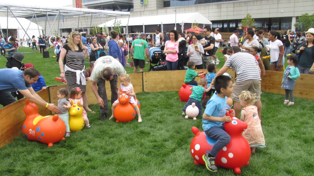 Kids ride inflated animal toys on the Lawn on D. (Photo by Rick Winterson)