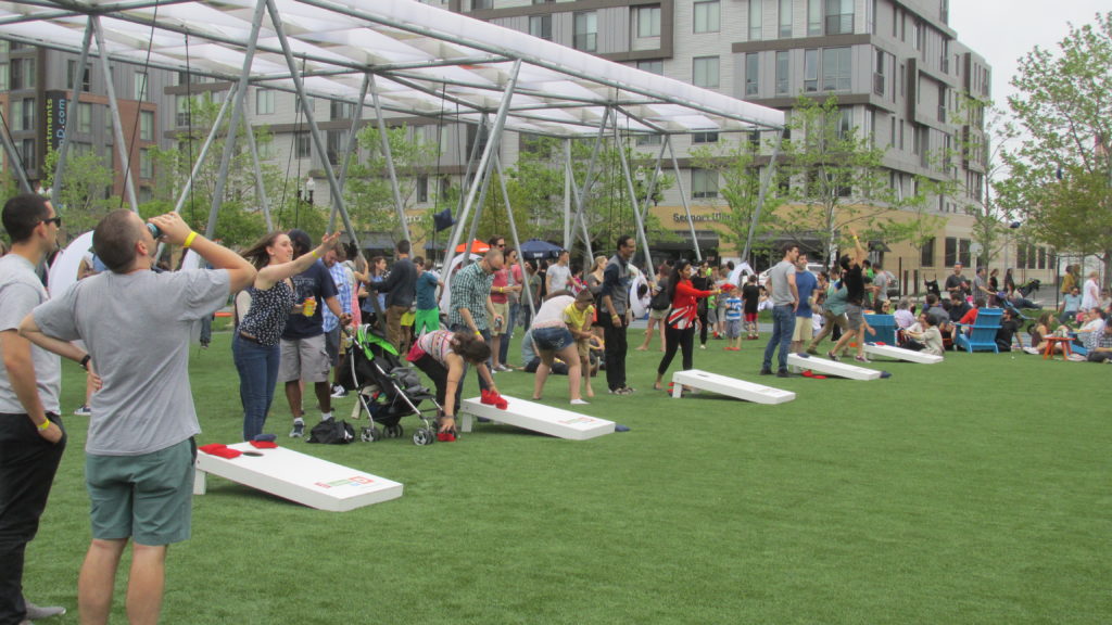 Cornhole entices more adults than kids at the Lawn on D opening day. (Photo by Rick Winterson)