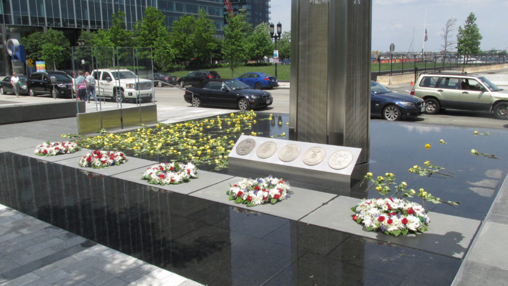 The Reflecting Pool at the base of the Fallen Heroes Memorial, brightly “decorated” with flowers.