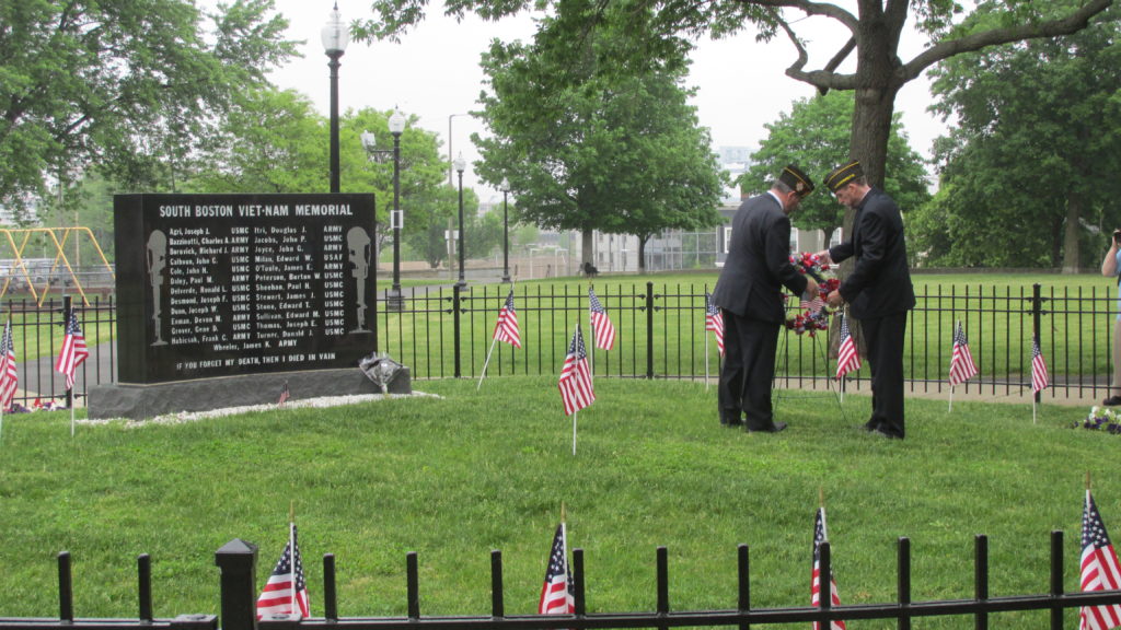 A wreath is solemnly emplaced in front of the 25 names inscribed on the Vietnam Memorial.