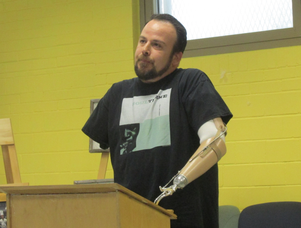 Peter Damon, a professional artist and a severely wounded veteran (Iraq), speaks to the South Boston Arts Association (SBAA) at their Saturday morning, June 11, meeting.