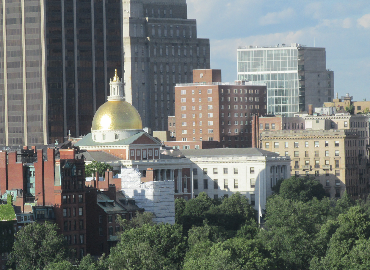 Across the Boston Common, a view of the State House nestled among the City’s skyscrapers. 