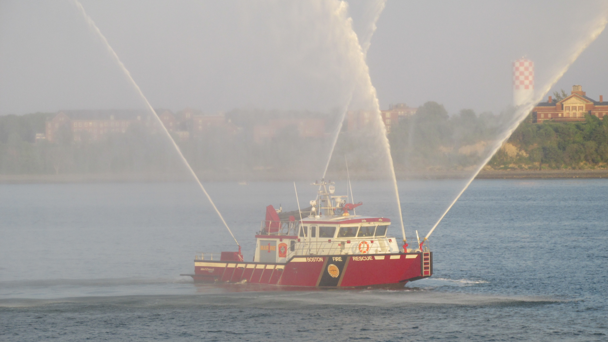 A traditional part of the Annual Club Cruise – a Massport fire boat greets the Provincetown II. That boat can pump around 500 gallons per minute.