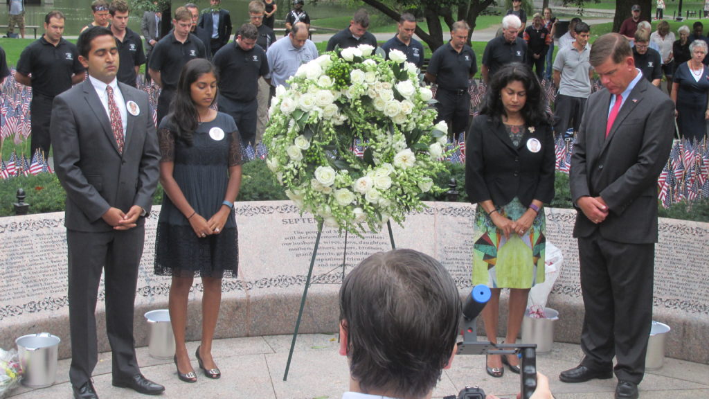 The Mathai family (who lost a husband and father on 9-11) observe a moment of silence with Mayor Walsh.